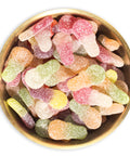 Mini sour dummy candy in a brass bowl on white background