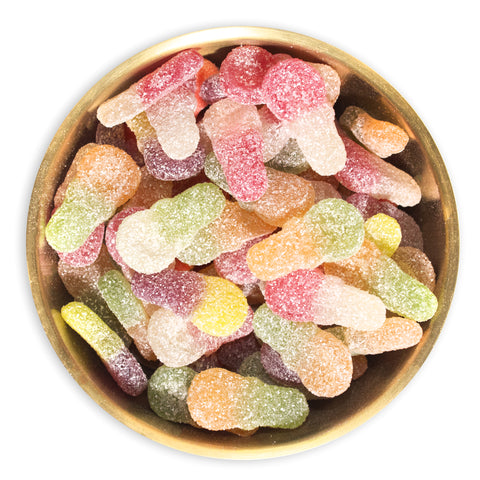 Mini sour dummy candy in a brass bowl on white background