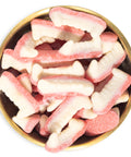 sour gummy fangs in brass bowl on white background