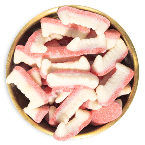 sour gummy fangs in brass bowl on white background