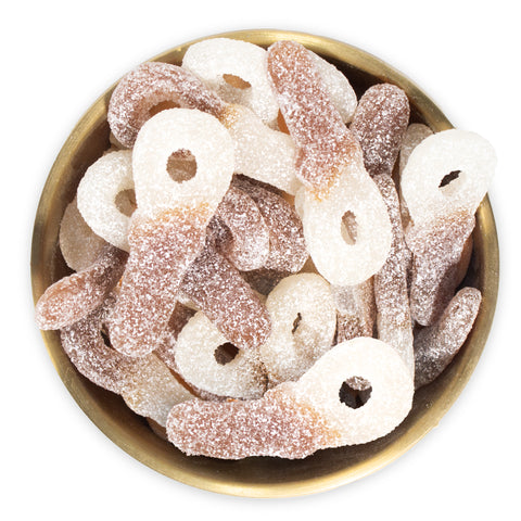 Sour Cola Dummies in brass bowl on white background