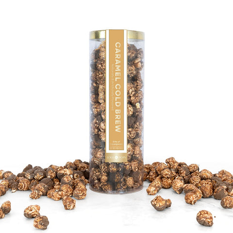 Caramel cold brew popcorn in a cylindrical container on a white background