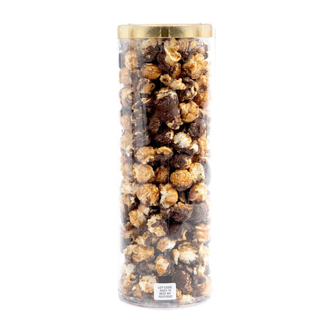 Cylindrical container filled with assorted popcorn flavors on a white background