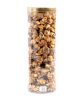 Tall cylindrical container filled with popcorn on a white background