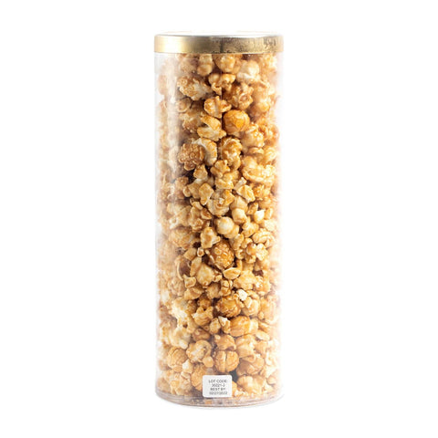 Cylindrical container filled with popcorn on a white background