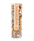 Tall cylindrical container filled with popcorn and nuts, labeled 'Peanut Butter Cup' on a white background.