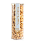Tube of sea salt caramel popcorn on a white background