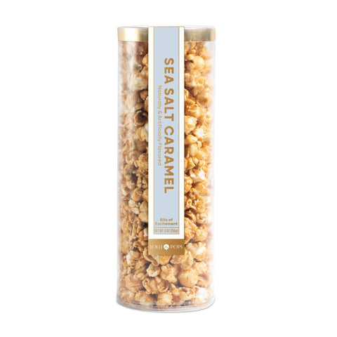Tube of sea salt caramel popcorn on a white background