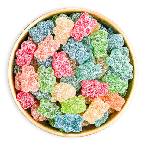 Colorful gummy bears in a gold bowl on a white background