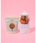 tasty ten gummy bears on pink background. styled in gum ball machine
